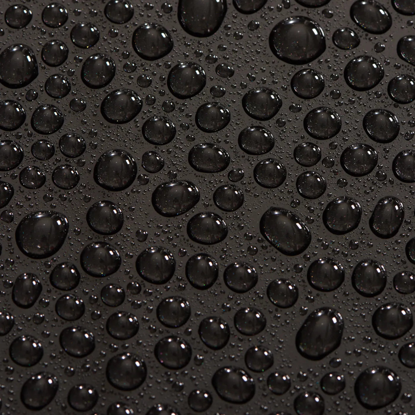 Close-up of water droplets on a black surface