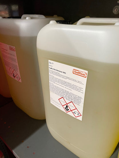 Two large white containers with labels on a dark background