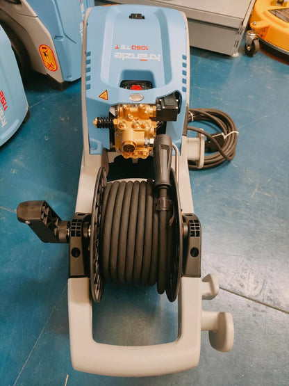 Power washer with hose reel on a blue floor