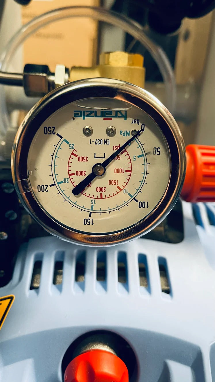Pressure gauge on a mechanical device with 'Suzuki' branding.