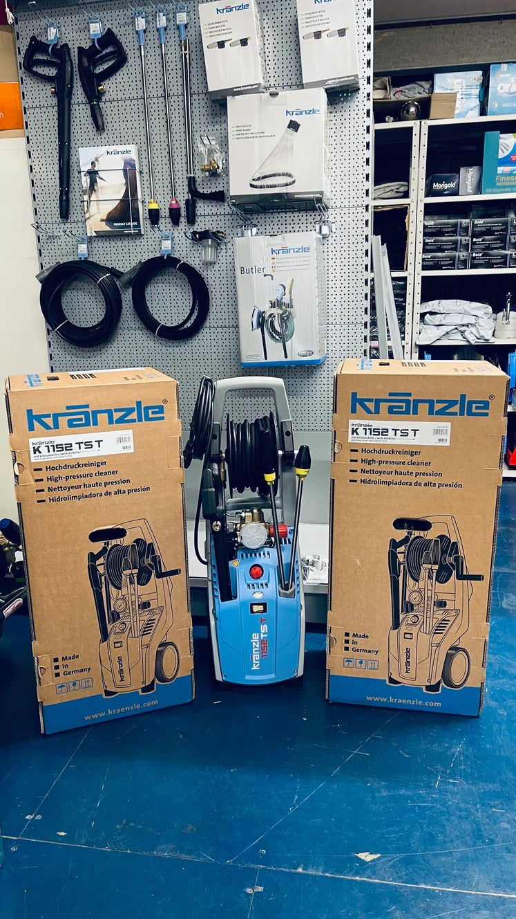 Kranzle pressure washers in boxes on a blue floor with a wall of tools in the background
