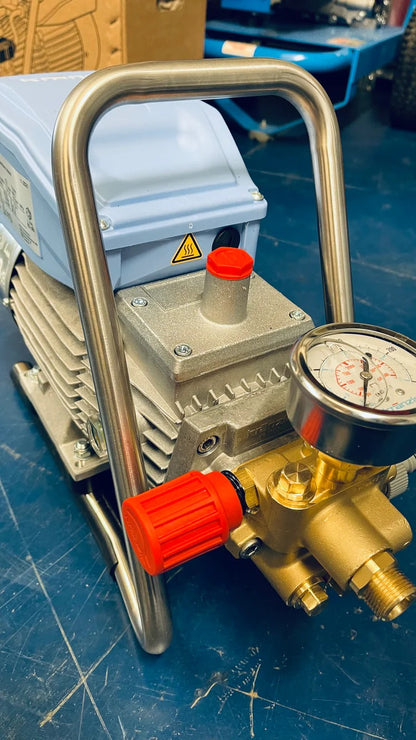 Pressure pump with gauge and red valve on a blue surface