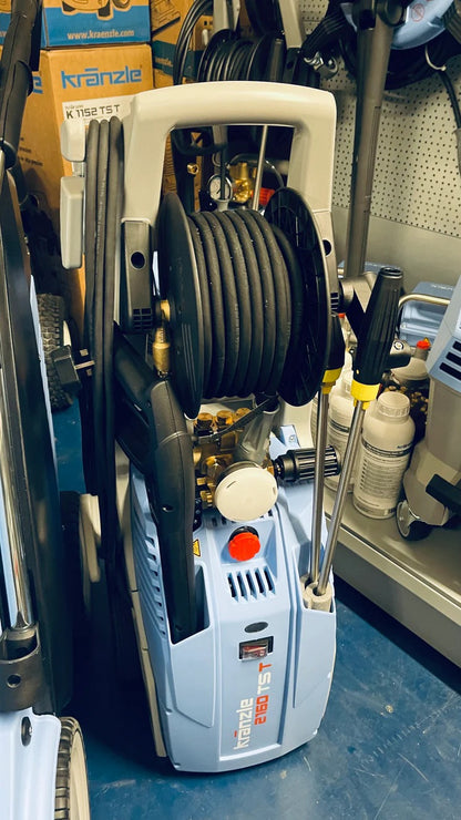 Pressure washer in a garage setting with tools and equipment around