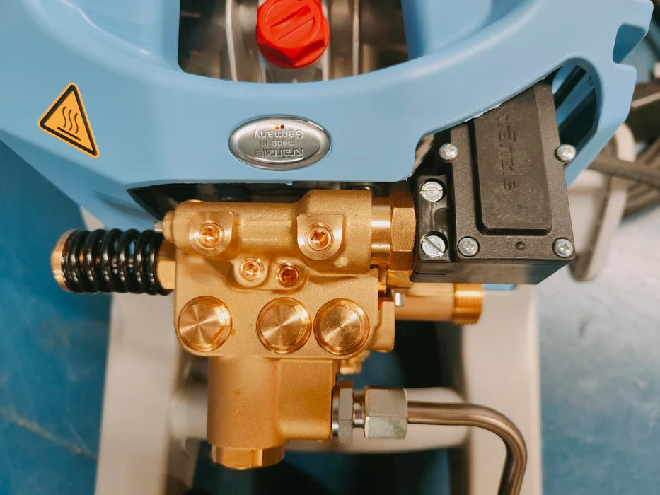 Close-up of a high-pressure washer with gold pump and blue casing.