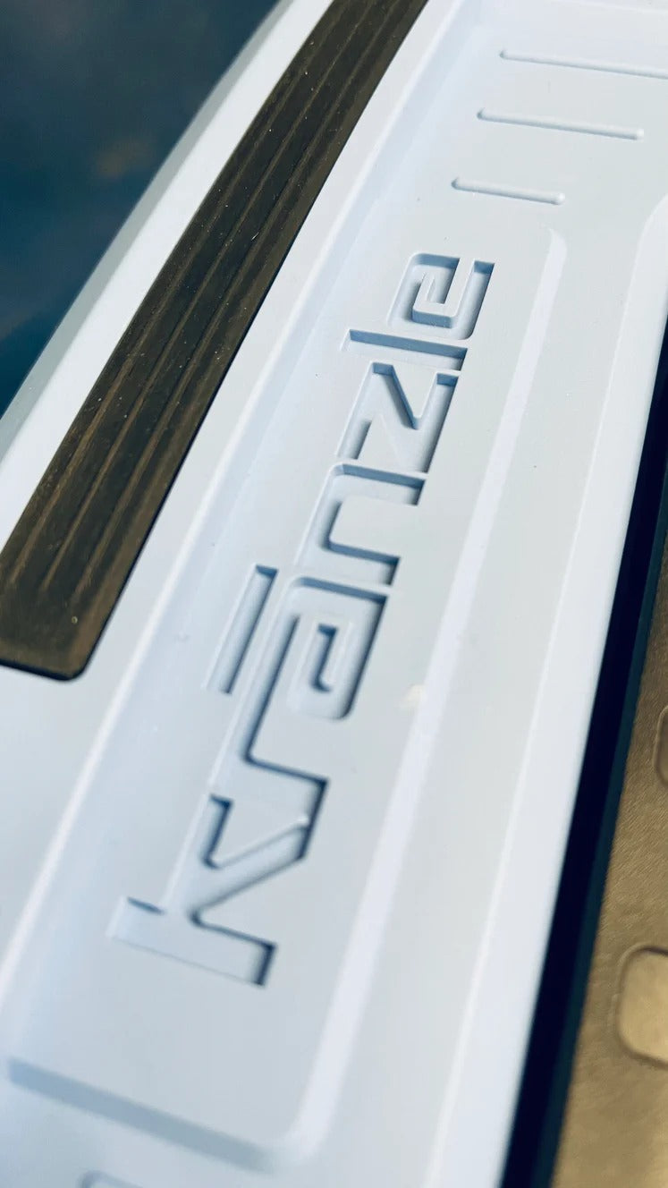 Close-up of a car door with a brand logo on a blurred background